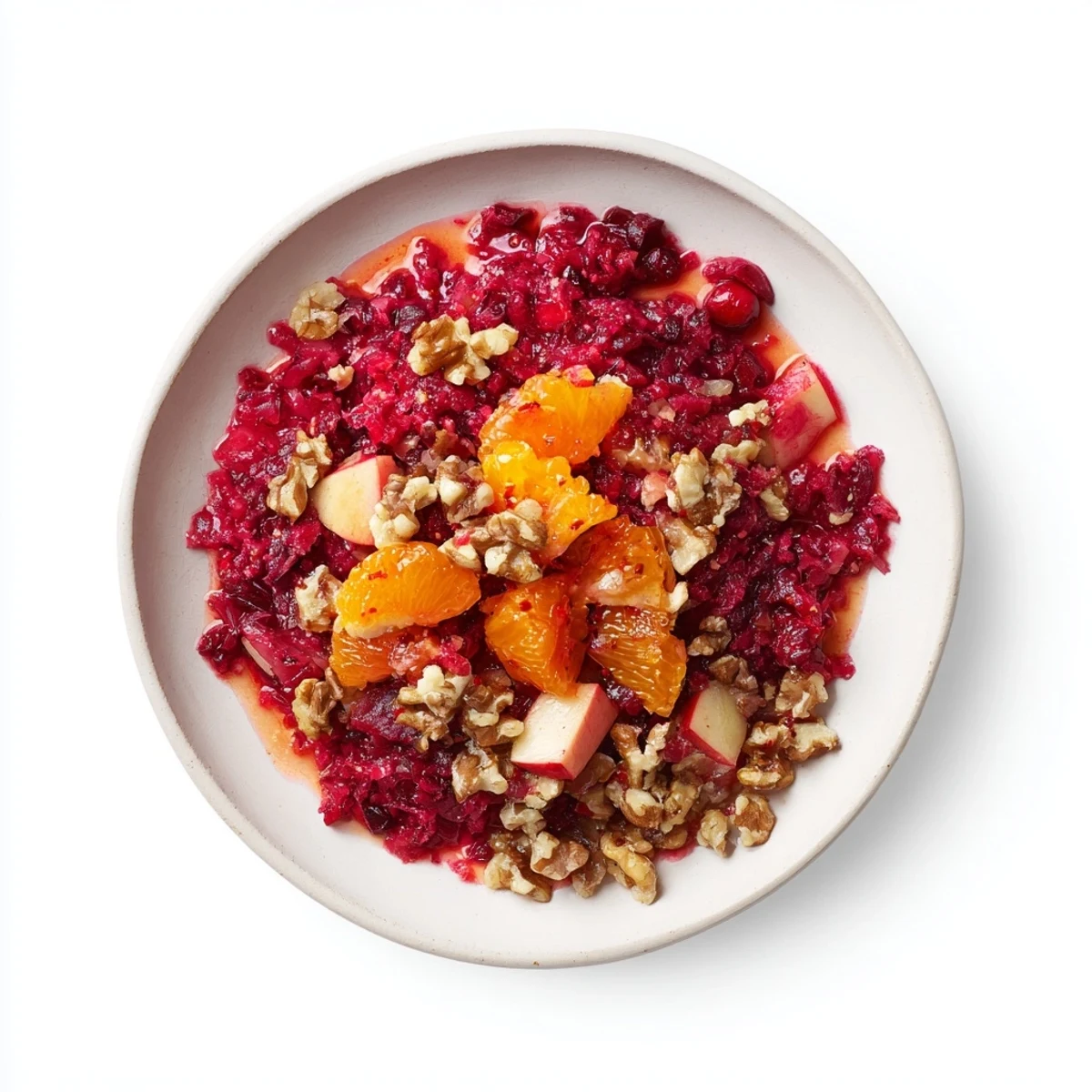 Vibrant red cranberry relish with chunks of apple and orange, ready to be served.