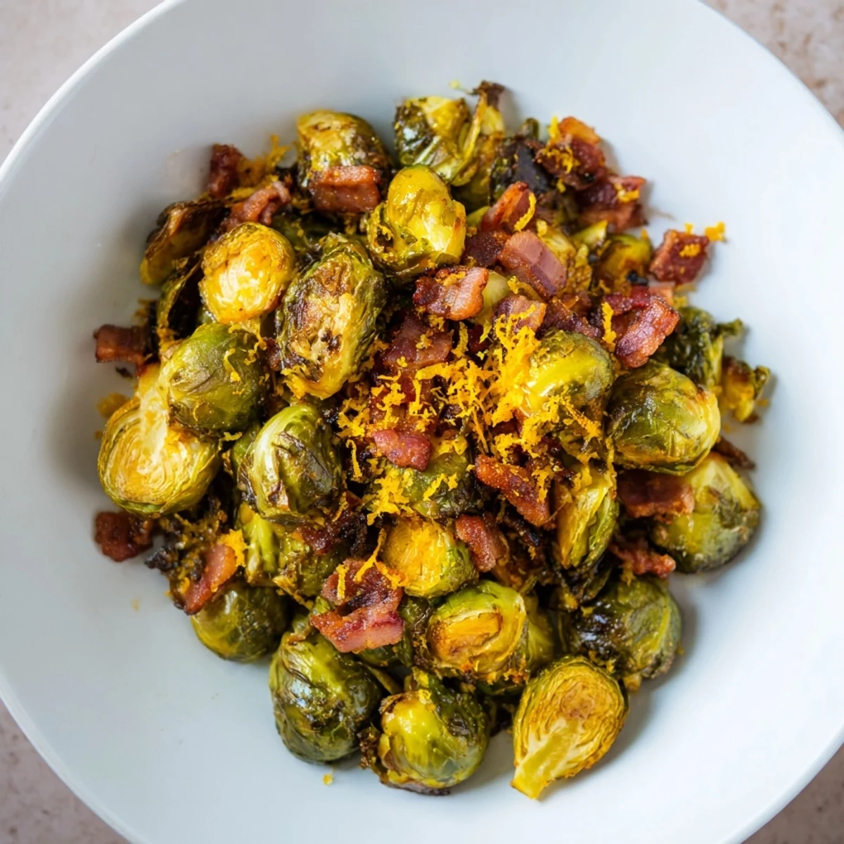 Crispy roasted Brussels sprouts and beef bacon, a delicious side dish with lemon zest and garlic.