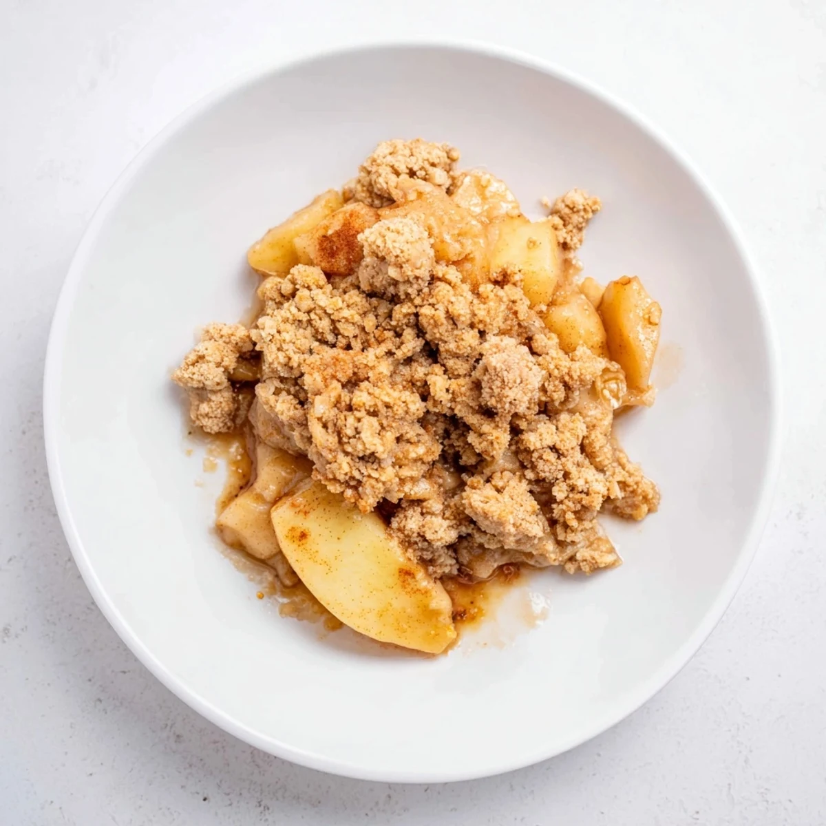 Golden, bubbly baked apple crisp with a crispy oat topping, perfect for dessert.