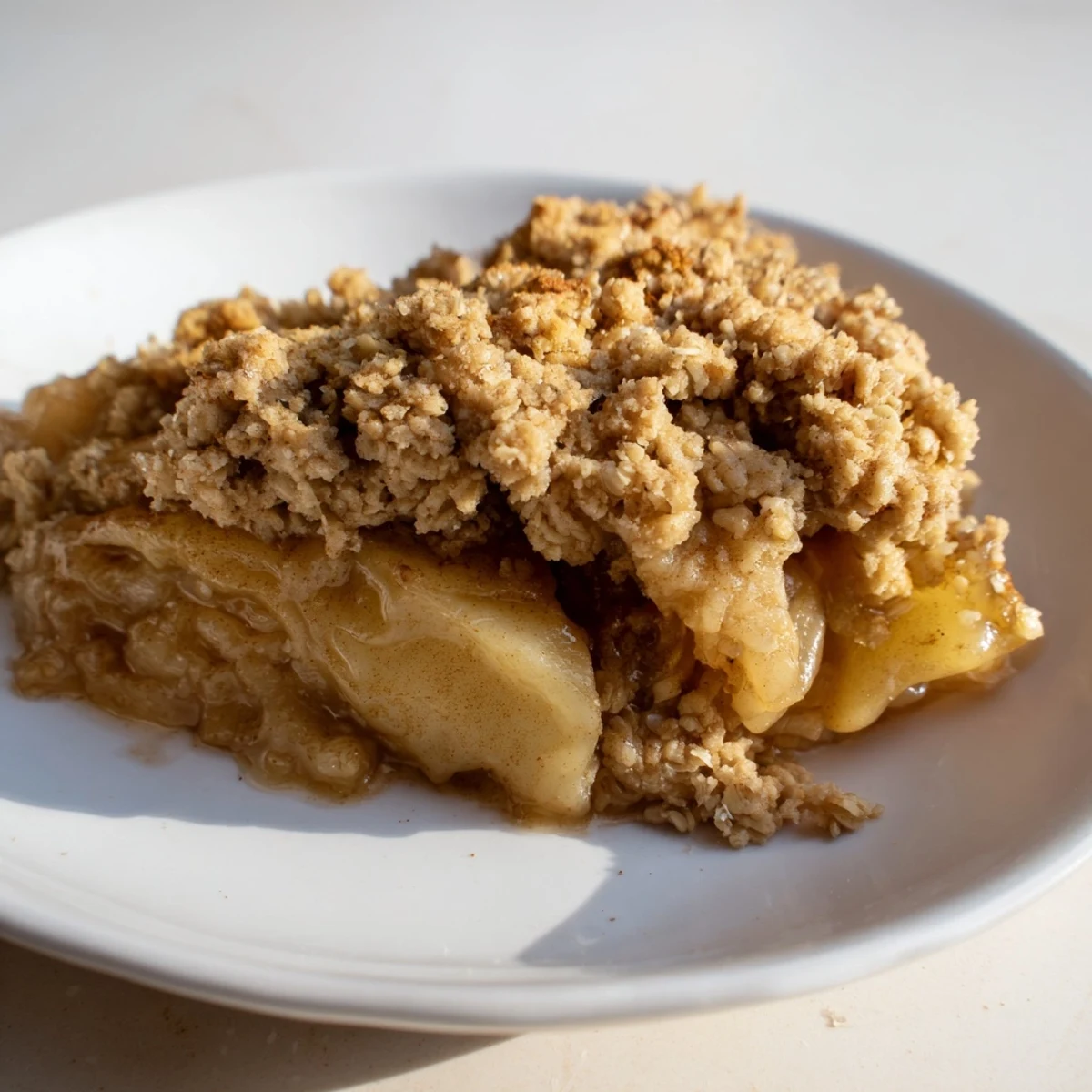 Warm baked apple crisp, served with vanilla ice cream, a classic American dessert.