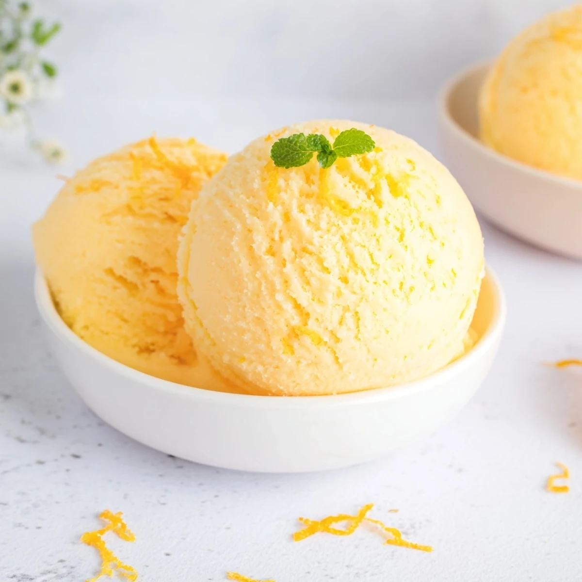 Bright yellow Lemon Sorbet Palate Cleanser, tangy and smooth, ready to refresh your taste buds.