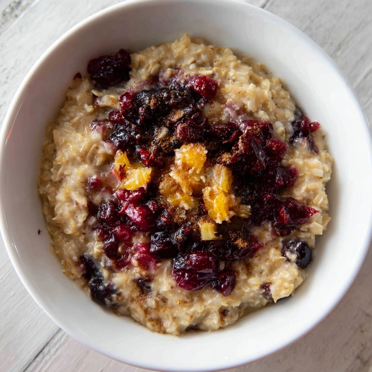 Close-up of a warm, fragrant cranberry crumble topping with a generous layer of crisp crumble.