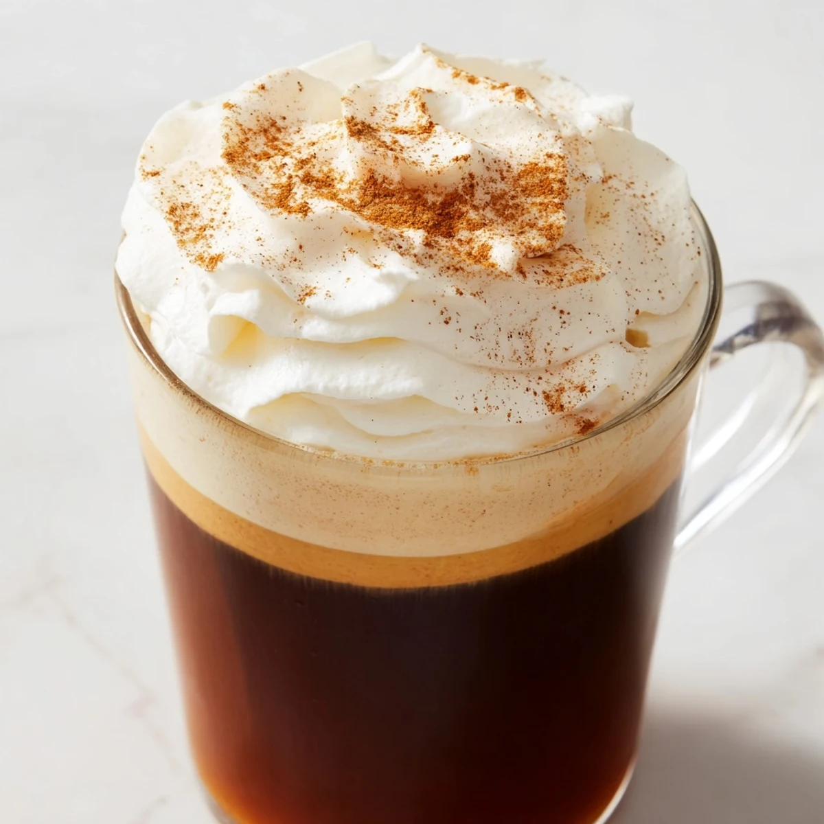 Close-up of a rich, golden Spiced Pumpkin Latte, ready to warm your hands and soul.