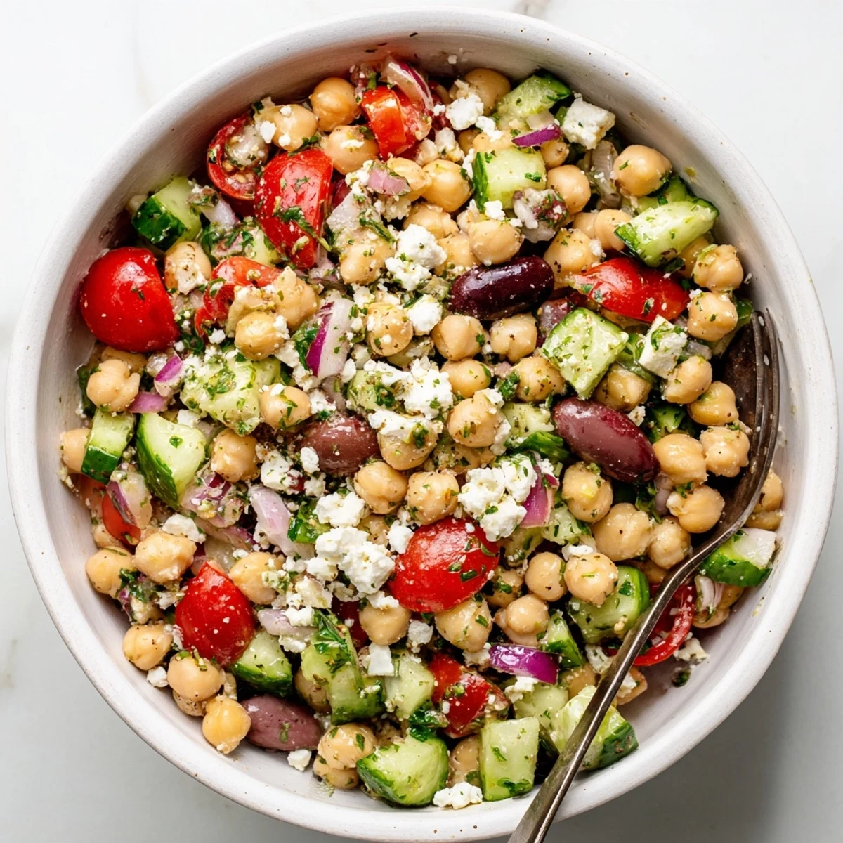 Mediterranean Chickpea Salad with Feta topped generously with crumbled cheese, ready to serve as a refreshing vegetarian lunch or side dish.