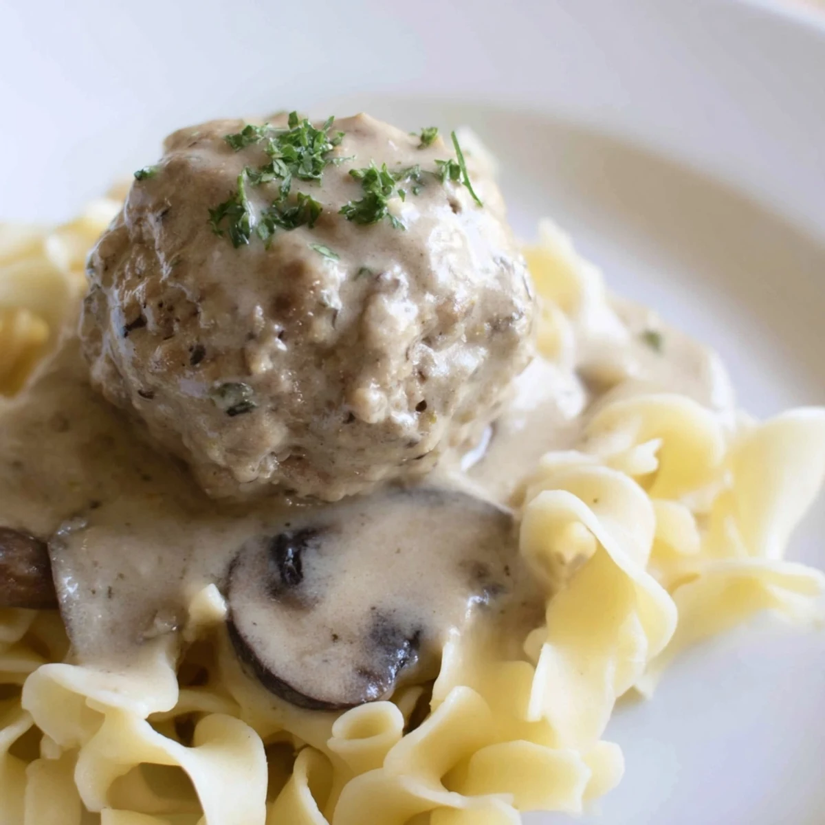 Turkey Meatball Stroganoff over Egg Noodles featuring golden-baked meatballs in rich, creamy mushroom sauce.