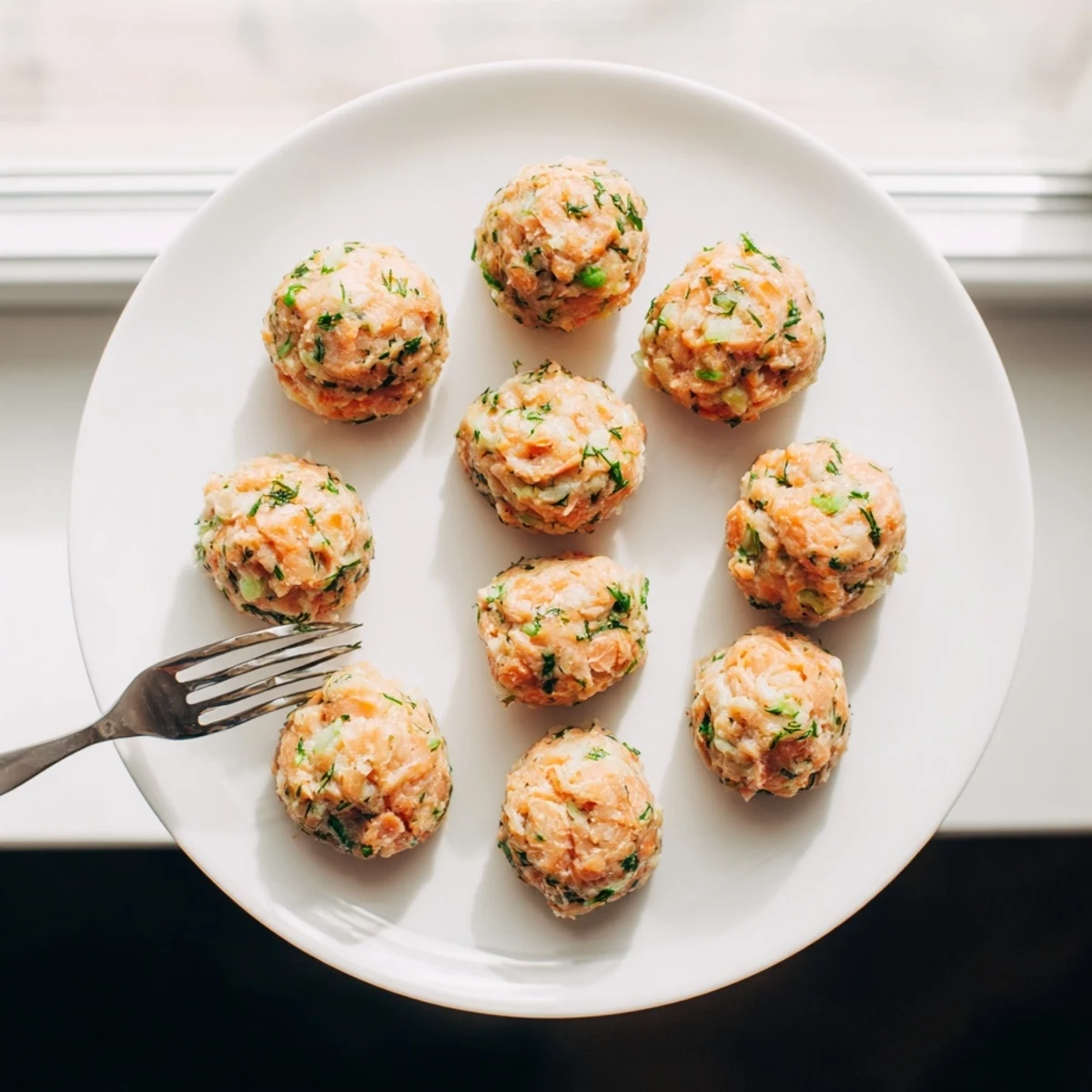 Baked Salmon Snack Bites on a baking sheet, golden and crispy, ready for party appetizers.