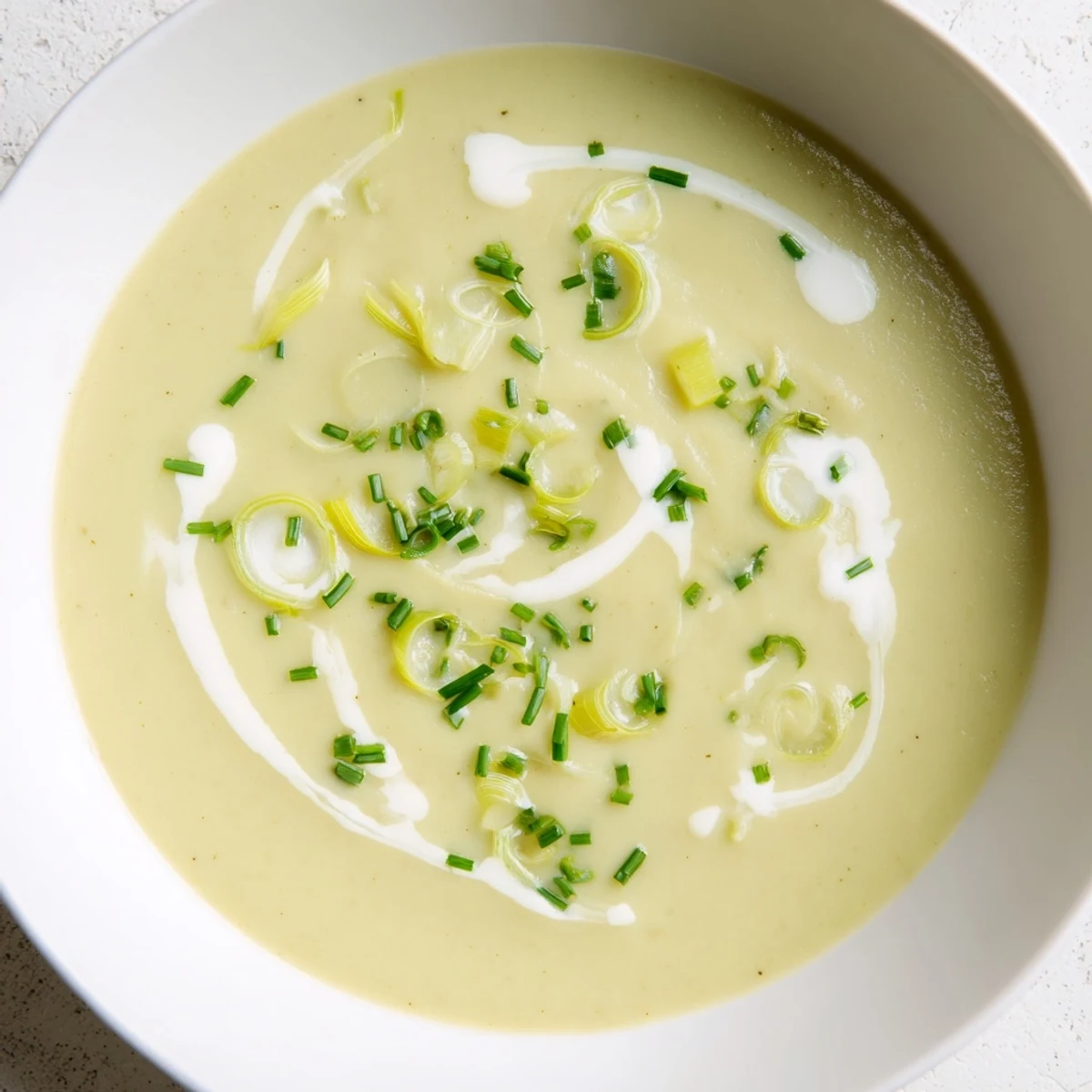 Velvety Leek and Potato Soup blended smooth in a pot, showcasing tender leeks and creamy potatoes.